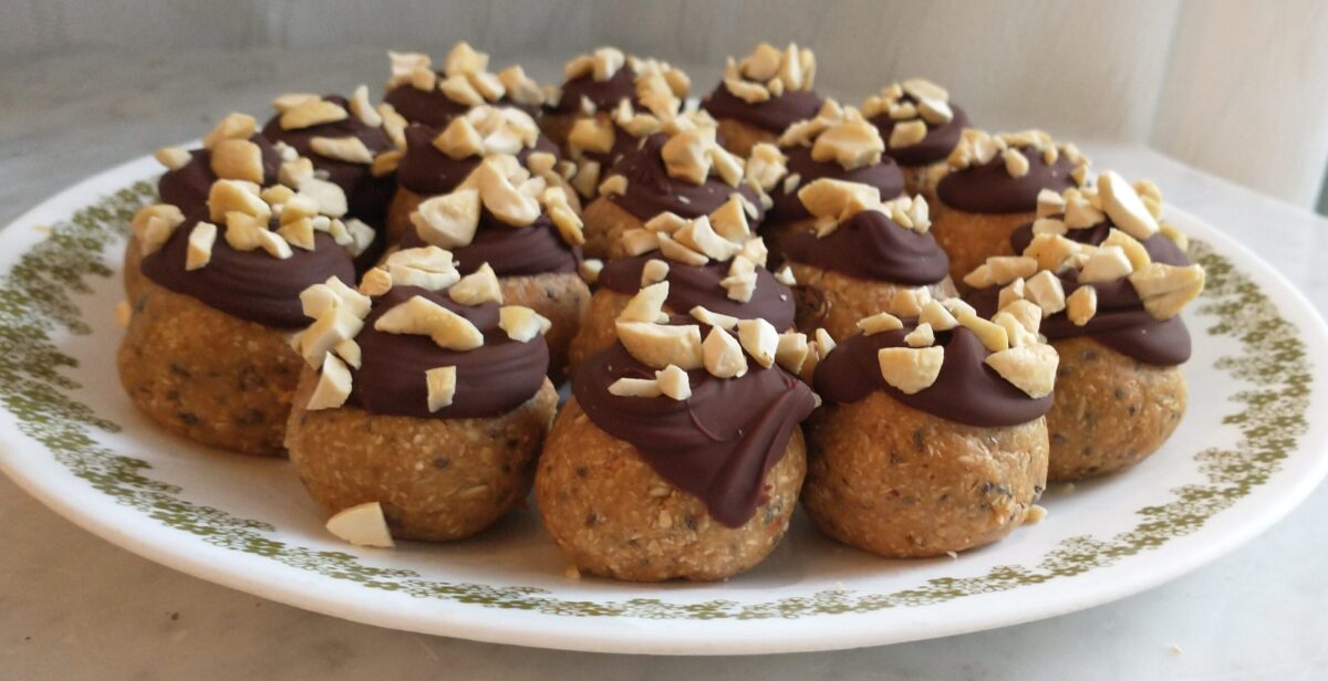 Peanut butter balls with chocolate coating and chopped cashews