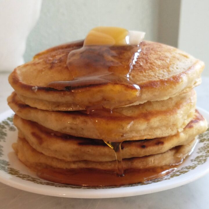 Fluffy maple pancakes with syrup and butter