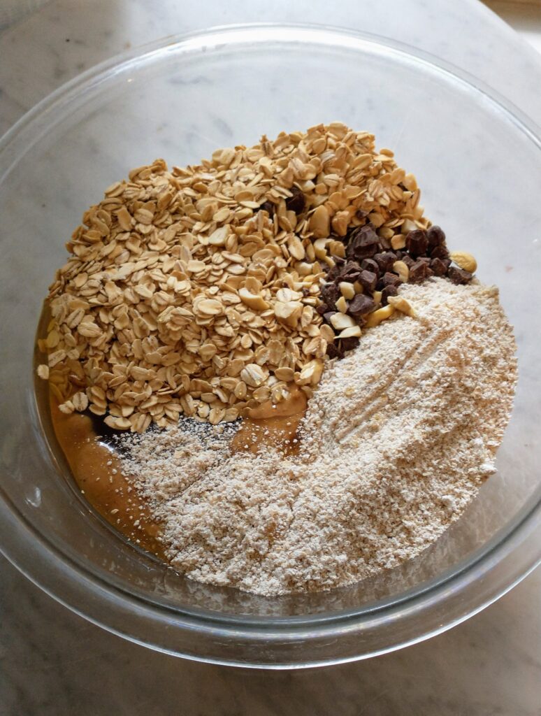 All ingredients for granola bars in bowl, unmixed