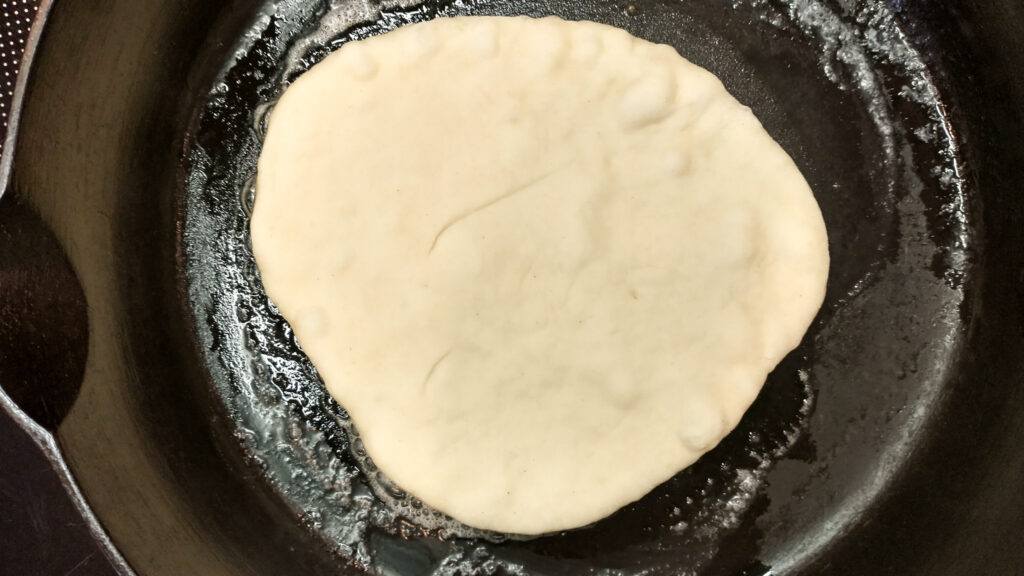 cooking flatbread in pan