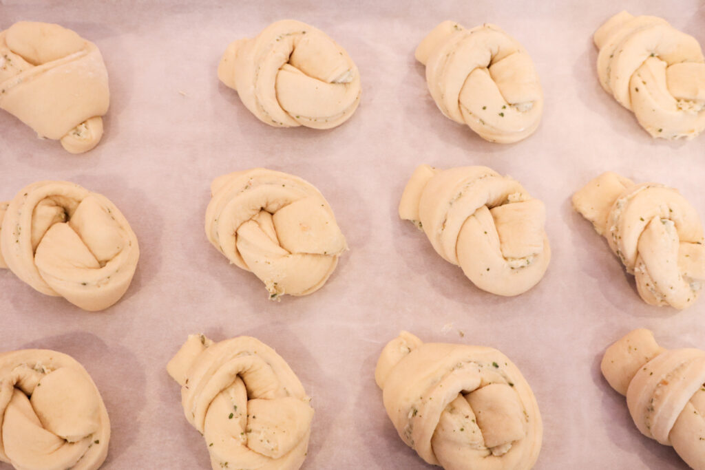 parmesan garlic knots on tray ready to be baked