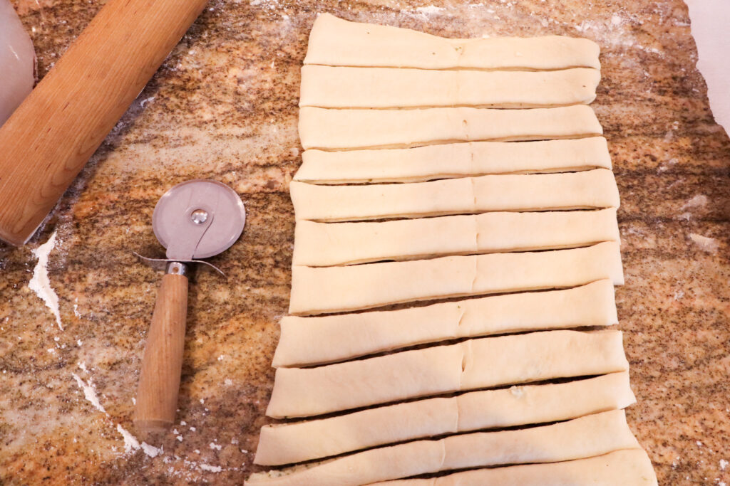 slicing the dough into ribbons