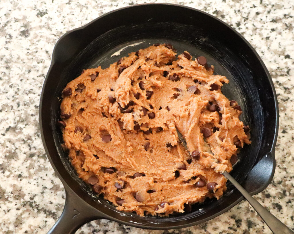 adding cookie dough to skillet