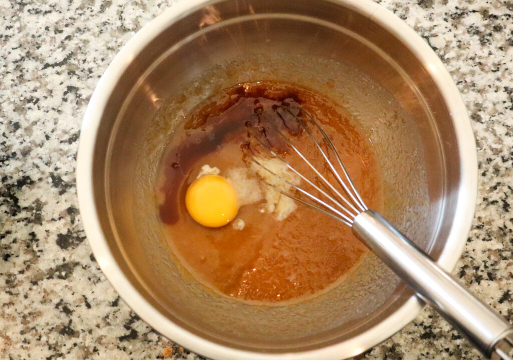 adding eggs to butter and sugar