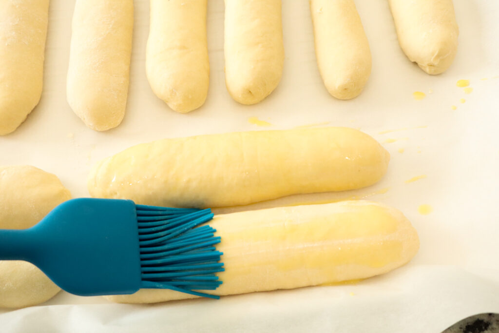 brushing the buns with egg wash