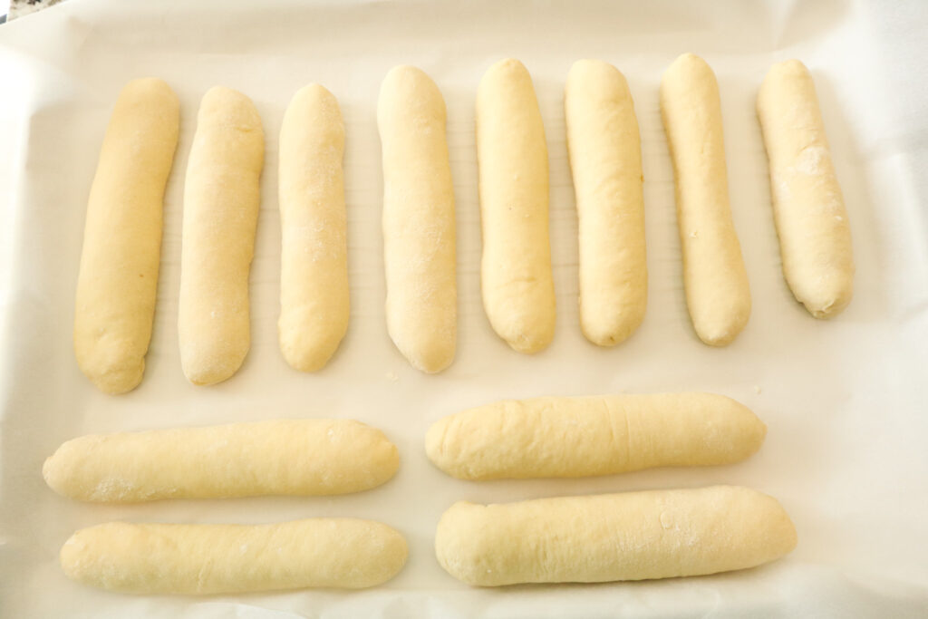 hot dog buns on baking sheet