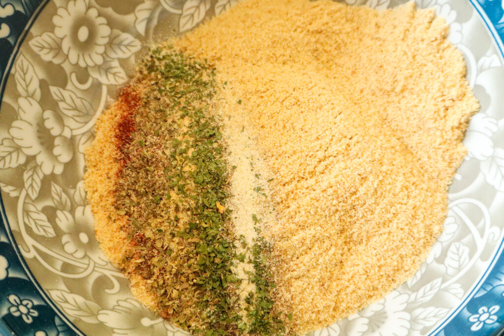 mixing in herbs and spices to breadcrumbs