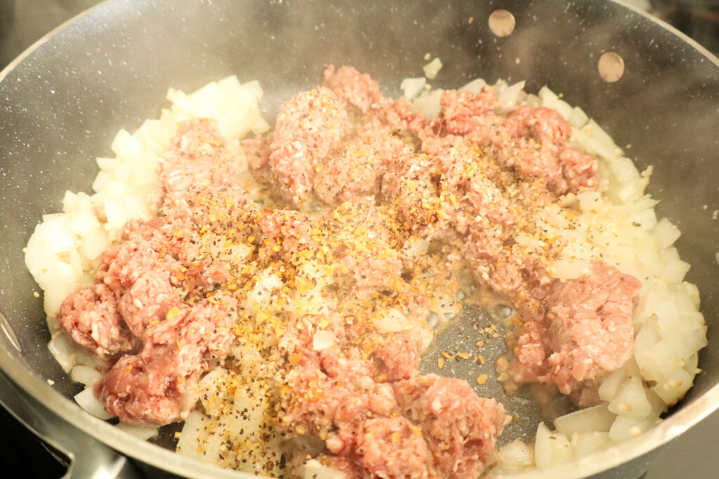 adding beef to sauted onions and garlic