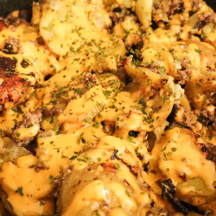 beef and potatoes skillet with melted cheese on top