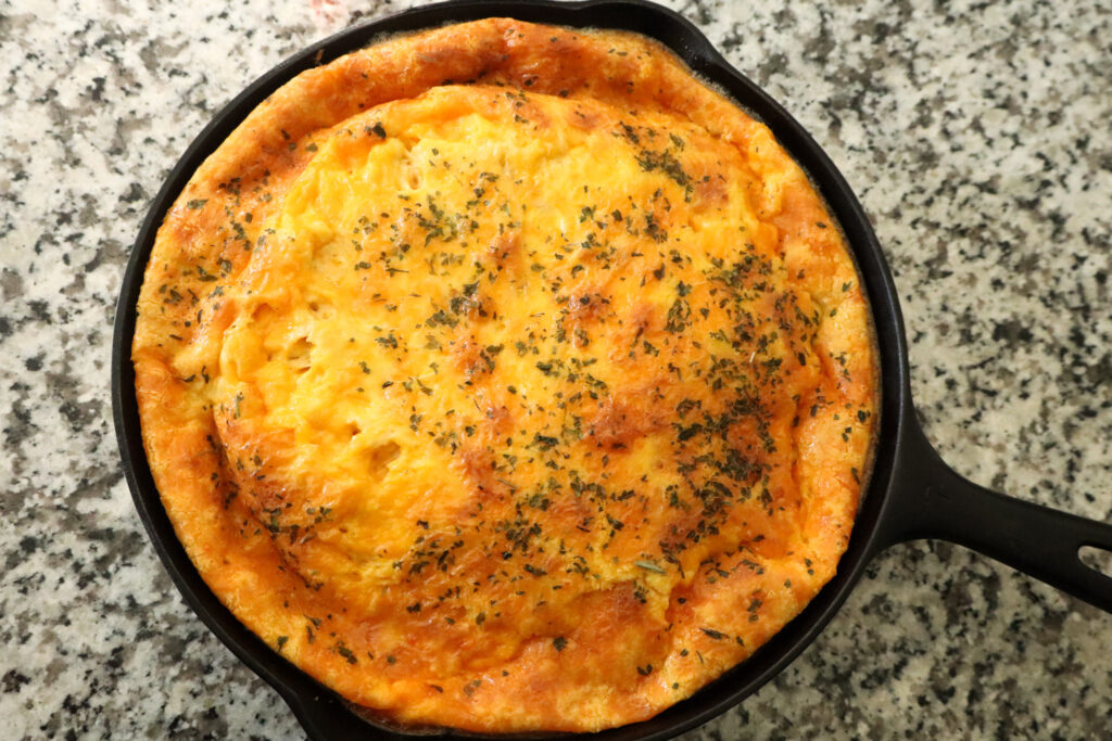 fully cooked ground beef and egg casserole in cast iron pan