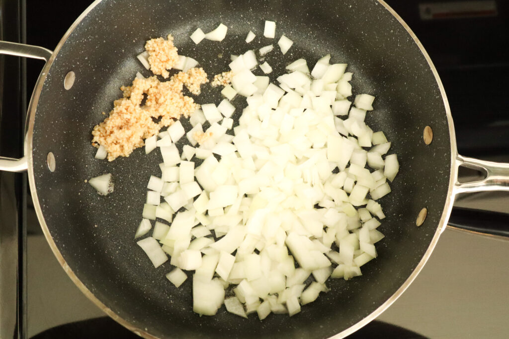 sautéing onions and garlic in frying pan