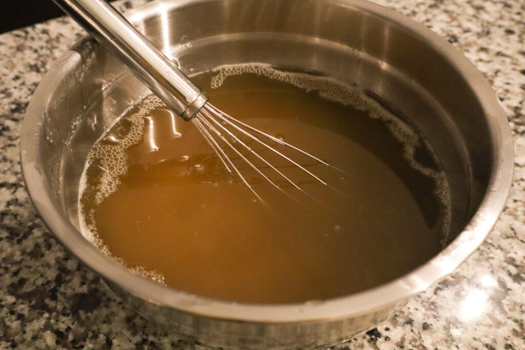 whisking together lye solution and oils