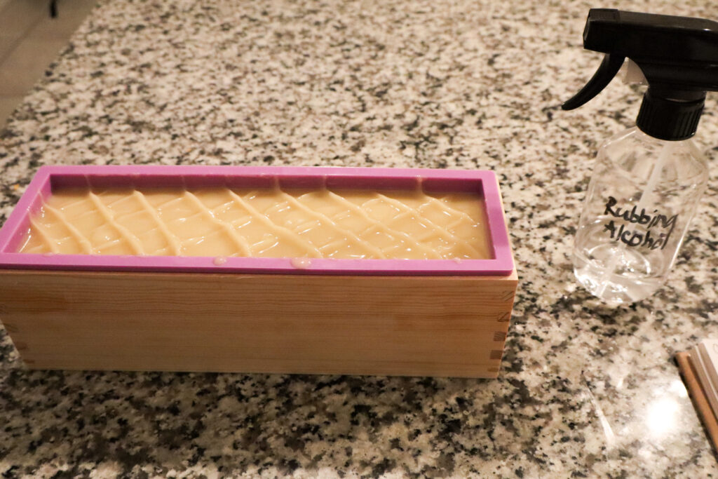 decorated cross hatch pattern on top of shea butter and tallow soap bars batter