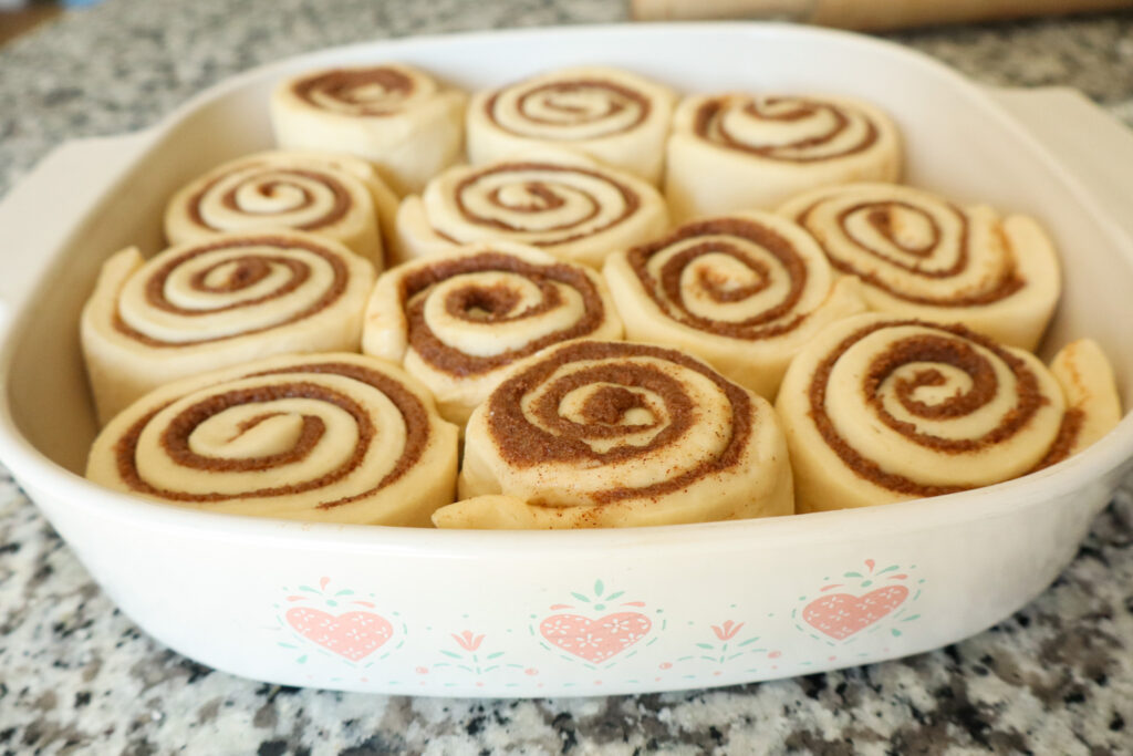 uncooked cinnamon rolls in baking pan