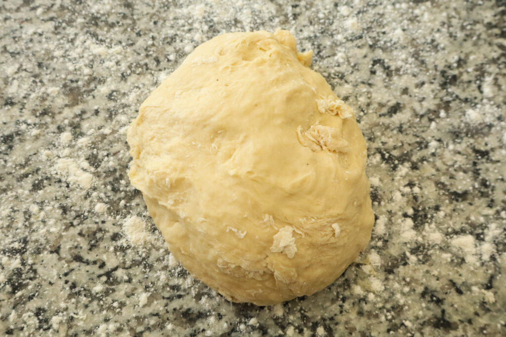 unkneaded dough on floured counter
