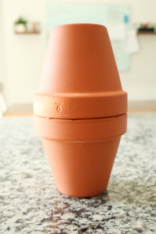 two terracotta pots super glued together