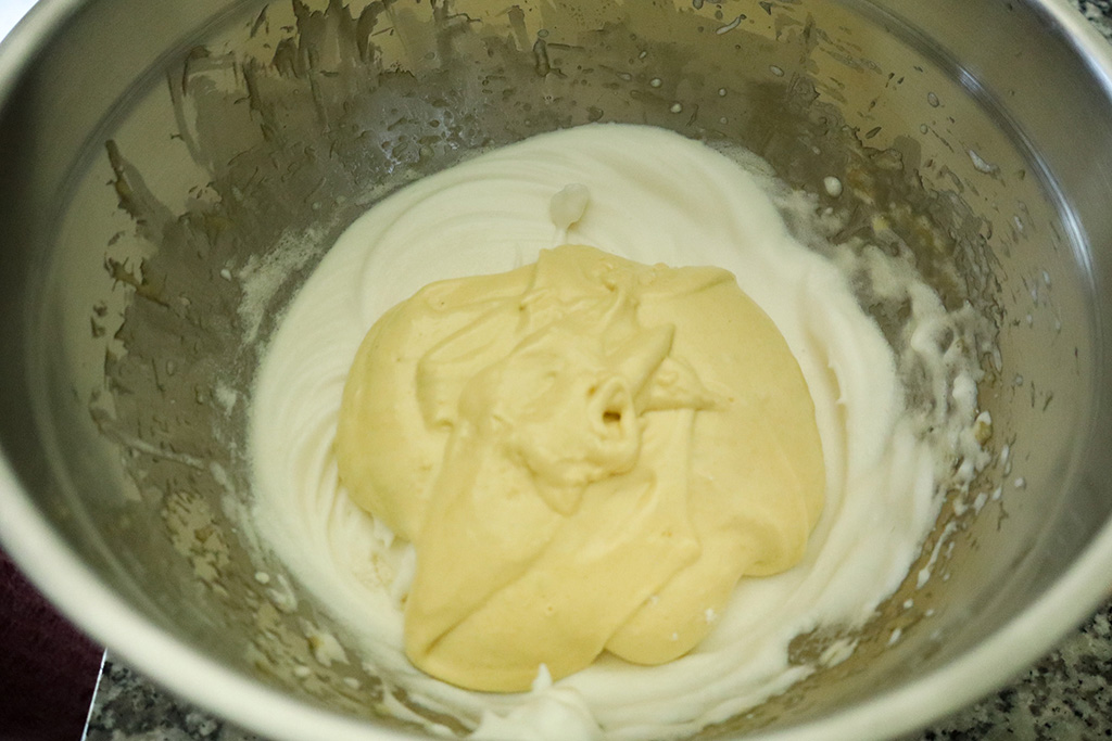 combing whipped egg yolks into whipped egg whites
