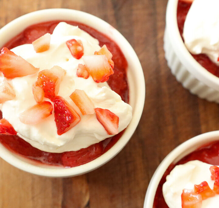 refined sugar free strawberry shortcakes topped with jam, whipped cream and diced strawberries