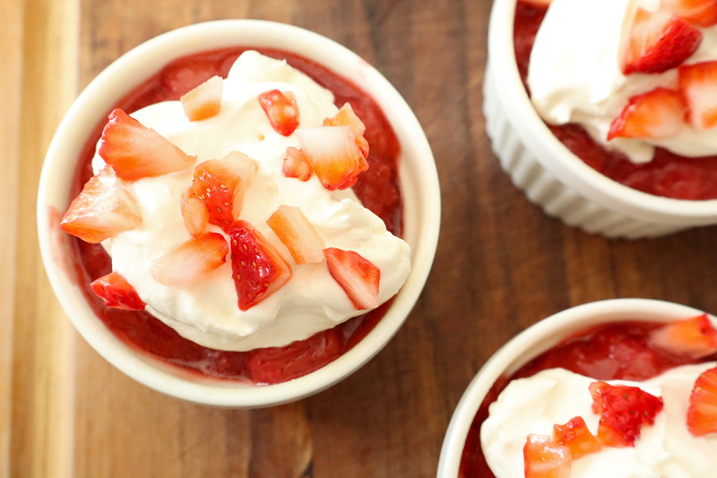 refined sugar free strawberry shortcakes topped with jam, whipped cream and diced strawberries