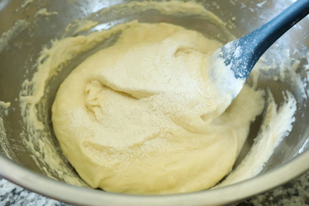 sifting flour into whipped eggs
