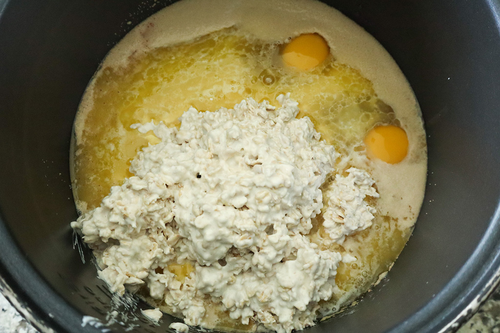 adding wet ingredients to bloomed yeast mixture