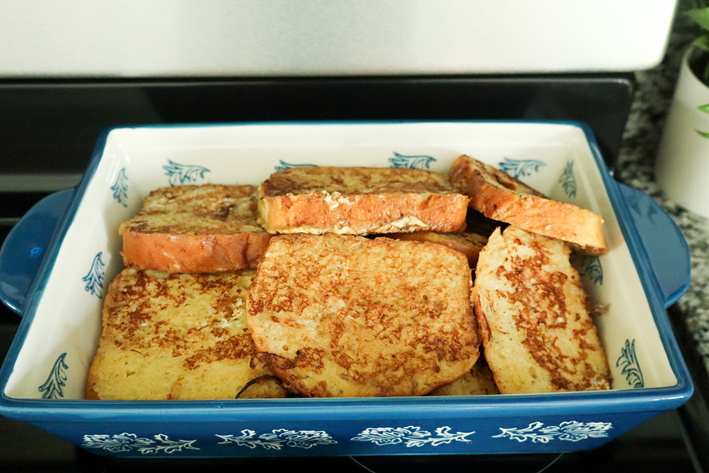 maple cinnamon french toast stacked in baking dish