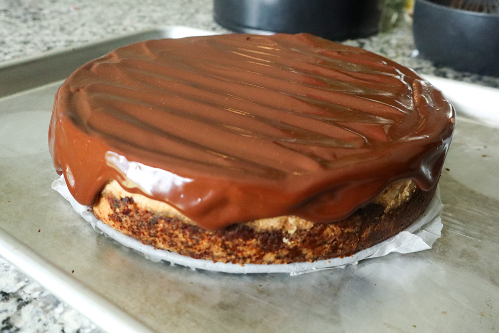 refined sugar free peanut butter cheesecake topped with dark chocolate ganache