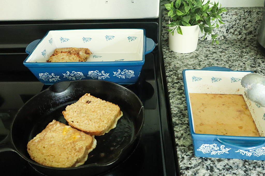cooking ample cinnamon french toast in a cast iron skillet