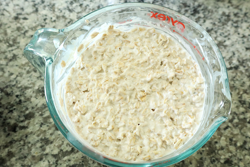 yogurt and oats mixed together in a pyrex measuring cup
