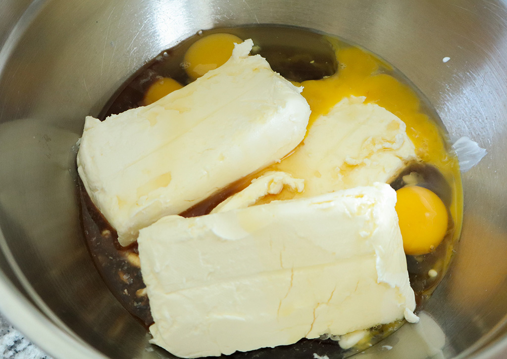 cookies and cream cheesecake filling ingredients in stainless steel mixing bowl