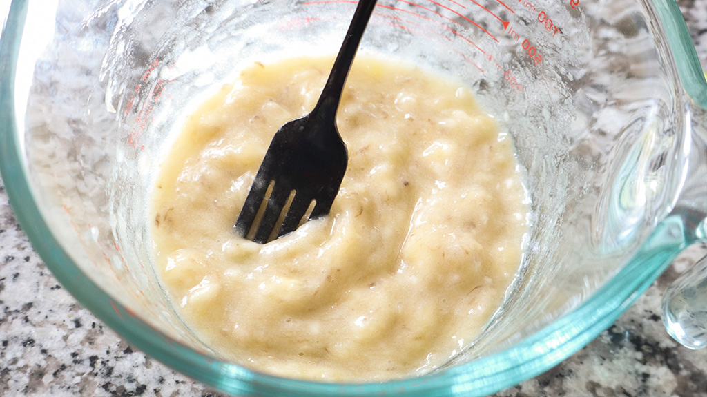 mashed banana in glass measuring cup