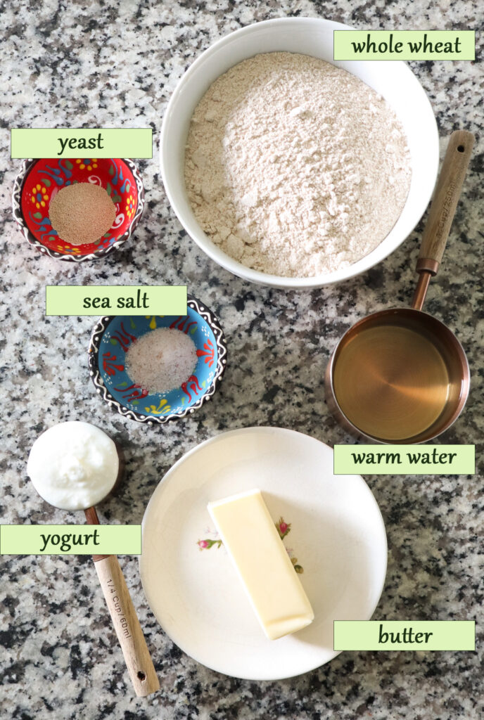 ingredients for whole wheat tortillas on counter in bowls and measuring cups